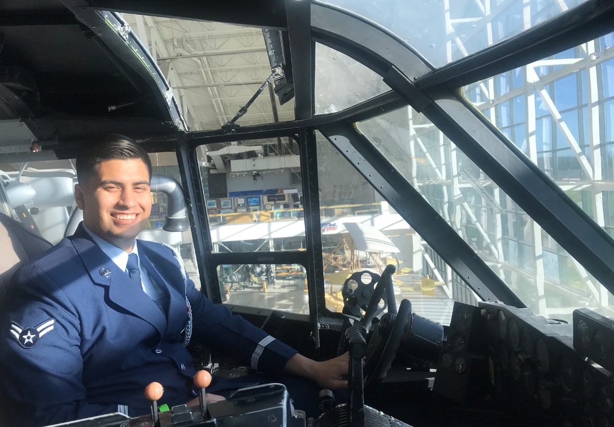 Andrew Amezquita in Air Force dress blues in the cockpit of an aircraft